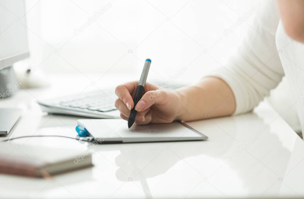Young woman working with digital graphic tablet