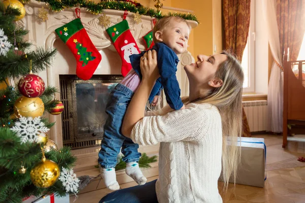 Mladá matka hraje s její chlapeček na podlaze na Vánoce tre — Stock fotografie
