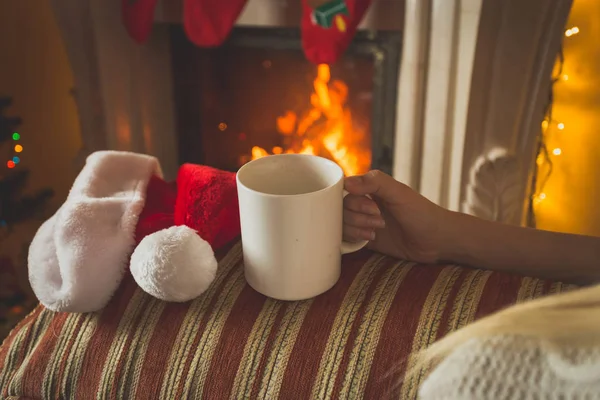 Cup of tea on sofa at fireplace — Stock Photo, Image