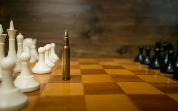 Conceptual photo of using bullet instead of chess piece — Stock Photo, Image