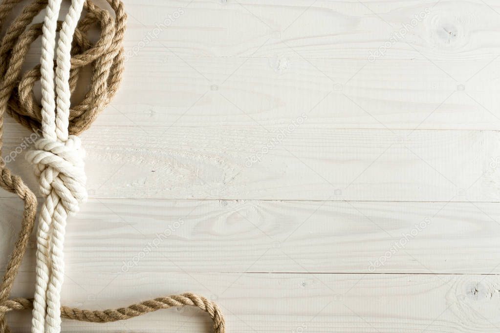 Closeup image of ship ropes on white wooden background