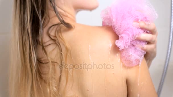 Closeup footage of sexy woman washing in shower with pink sponge — Stockvideo