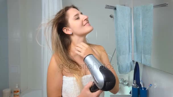 Slow motion footage of beautiful young woman drying hair after having bath — Stock Video