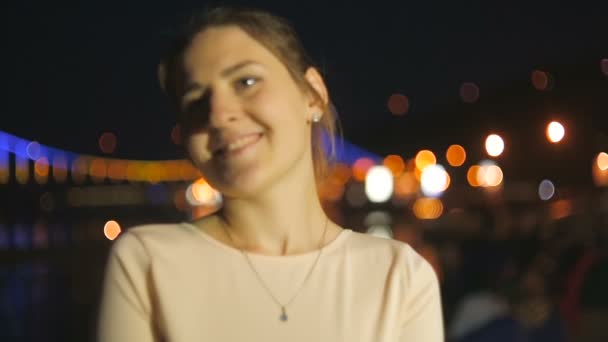 Dolly shot of beautiful young woman standing on seafront at evening — Stock Video