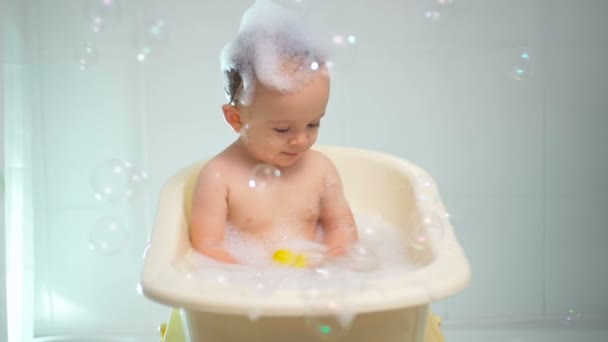 Vídeo en cámara lenta de lindo niño de 1 año de edad, teniendo tiempo de baño — Vídeo de stock