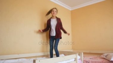 Mutlu genç kız yatakta atlama Slow motion video