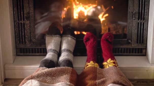 Slow motion footage of couple in love lying under plaid next to fireplace — Stock Video