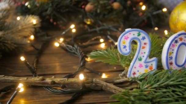 Closeup 4k footage from slider of colorful decorations, glowing lights, baubles and candles with 2018 numbers — Stock Video
