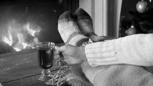 Black and white closeup image of young woman holding cup of tea — Stock Photo, Image