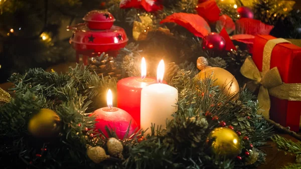 Beautiful Christmas background with glowing candles, gift boxes — Stock Photo, Image