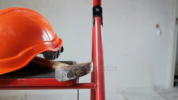 Μήκος σε πόδηα εργαλεία εργασίας και κόκκινο κράνος στο διαμέρισμα υπό ανακαίνιση. Έννοια του κτιρίου — Αρχείο Βίντεο