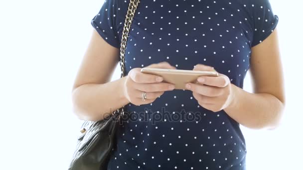 4k primer plano del pie de la mujer joven en azul camiseta escribiendo mensaje en el teléfono móvil — Vídeo de stock