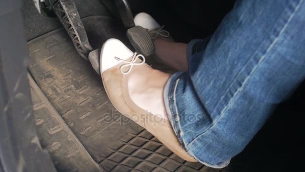 Slow motion video of female drivers legs in ballet flats while driving car with manual gearbox — Stock Video