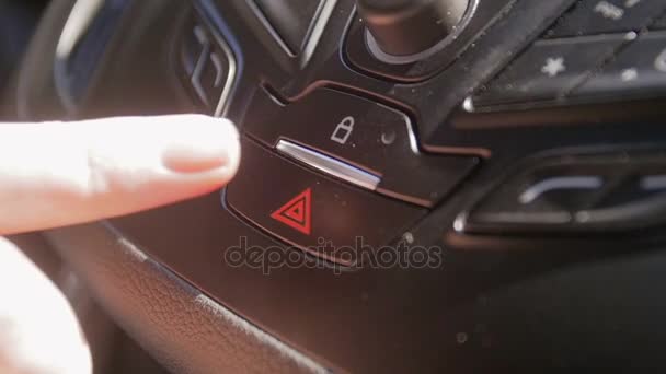 Closeup slow motion video of female driver pressing red emergency button on car dashboard — Stock Video