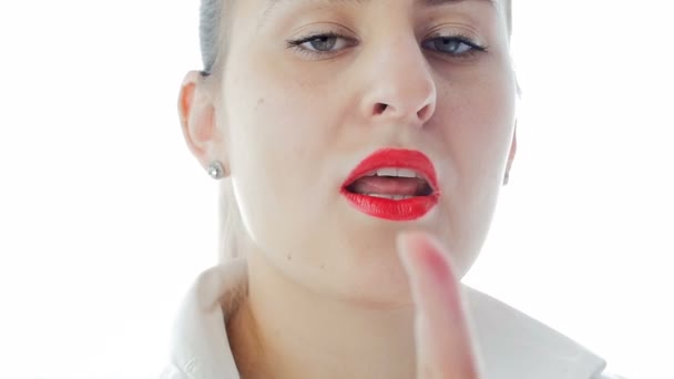 Closeup slow motion footage of sexy woman with red lipstick holding finger at lips — Stock Video