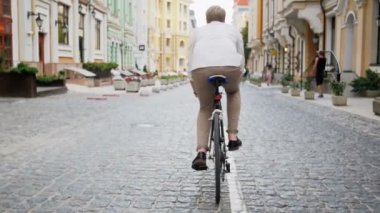 Genç adam vintage spor bisiklet üzerinde çalışmaya commuting ağır çekim görüntüleri