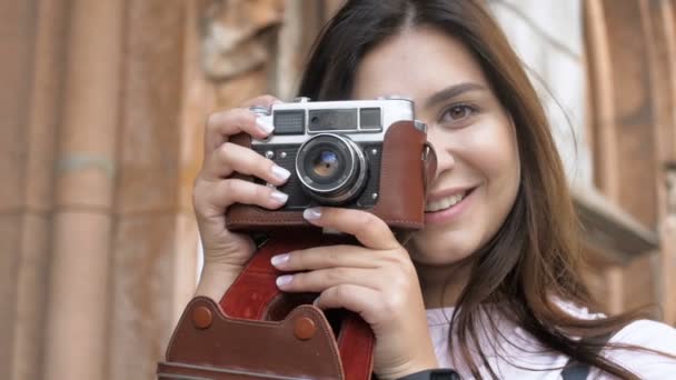 Slow motion video av leende brunett tjej att göra fotografier på gamla manuell kamera — Stockvideo