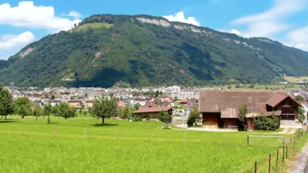 Filmaufnahmen vom Reiten durch schöne Wiesen und Höfe in der Schweiz — Stockvideo