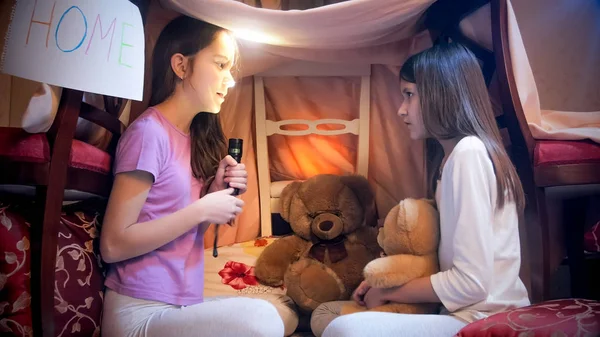 Two cute girls in pajamas telling stories at dark night — Stock Photo, Image