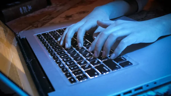 Closeup photo of female hands on laptop keyboard at night — Stock Photo, Image