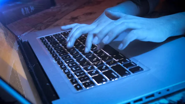 Closeup image of girl typing message on laptop at night — Stock Photo, Image