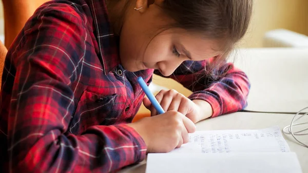 Toned photo of girl writing in copybook with ink pen — Stock Photo, Image