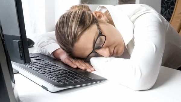 Closeup image of young woman felt tired sleeping on desk at office — Stock Photo, Image