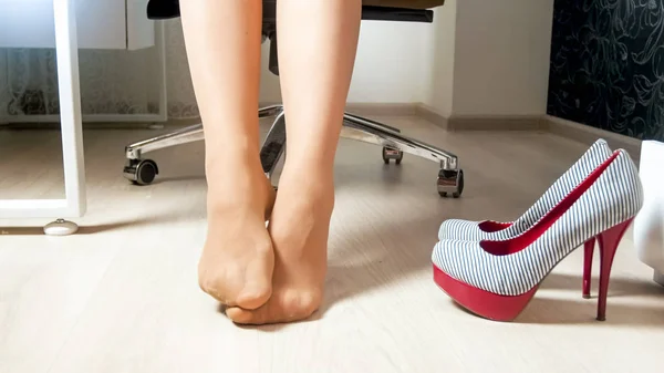 Closeup image of tired feet in pantyhose after hard workday — Stock Photo, Image