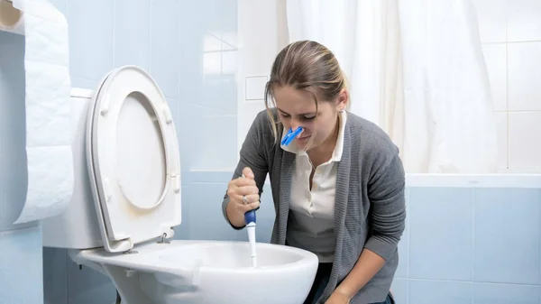 Portrait de jeune femme brune lavant les toilettes avec brosse — Photo