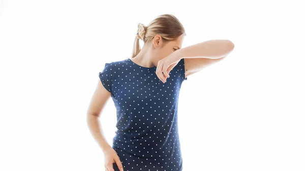 Isolated portrait of young woman smelling her smelly armpits — Stock Photo, Image