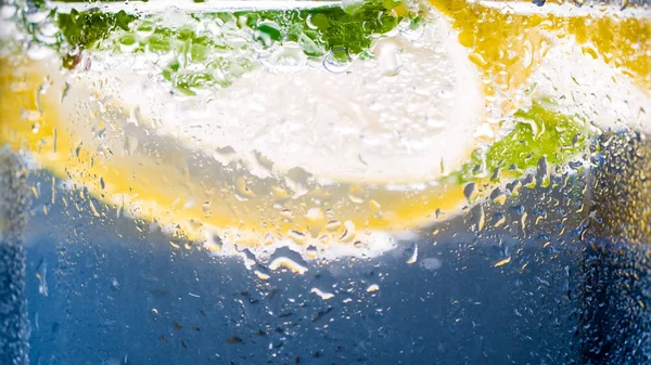 Closeup image of water drops on cold glass of lemonade — Stock Photo, Image