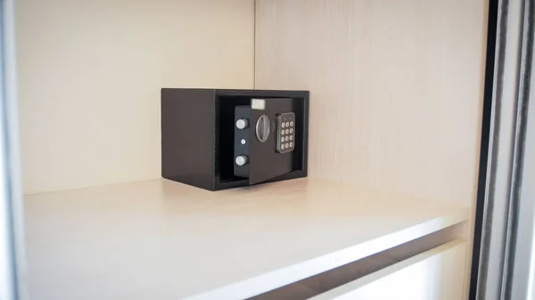 Closeup image of small open safe box in hotel room — Stock Photo, Image