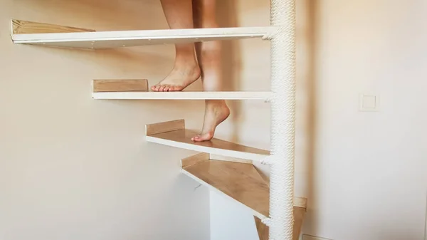 Closeup image of female feet walking up wooden stairs at house — Stock Photo, Image