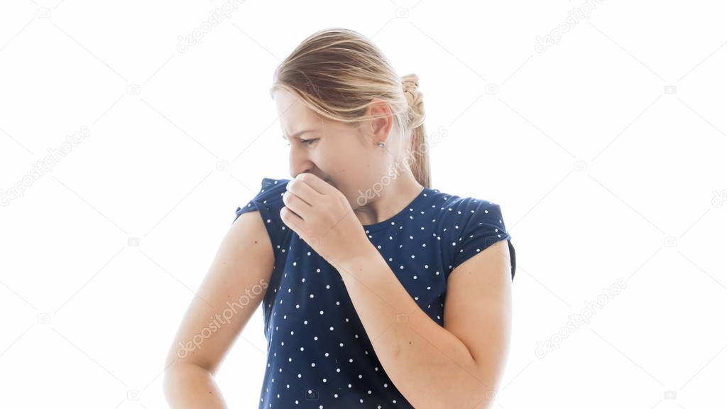 Isolated portrait of young woman smelling her armpits