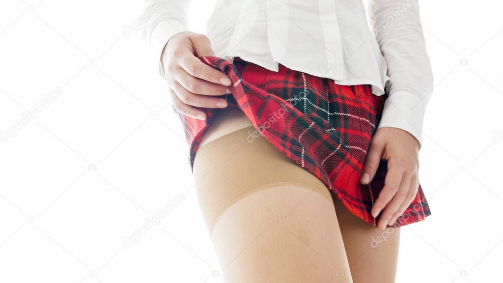 Closeup isolated image of sexy student in stockings lifting her skirt