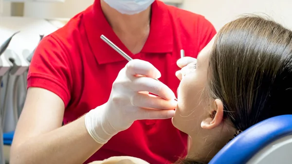Zbliżenie obrazu z dentysta w gumowe rękawiczki badanie zębów u pacjentów z instrumentami — Zdjęcie stockowe