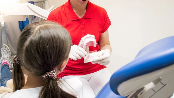 Zbliżenie obraz kobiet stomatolog dziecięcy, wyjaśniając, jak używać szczoteczki do zębów — Zdjęcie stockowe