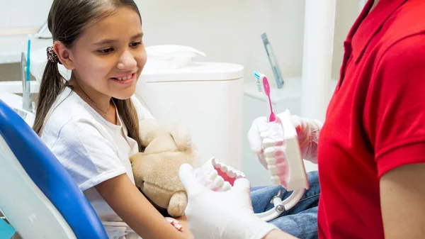 Ritratto di ragazza sorridente lezione di ascolto nello studio dentistico sull'importanza dell'igiene dei denti — Foto Stock