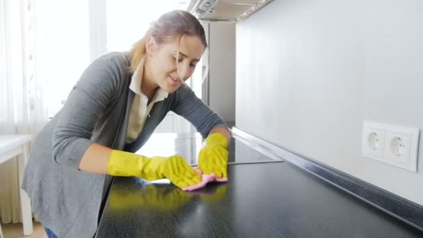Nahaufnahme in Zeitlupe: junge Hausfrau putzt Küchenarbeitsplatte mit Tuch — Stockvideo