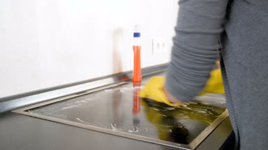 Mutfak elektrikli ocakta closeup sürtünme ve temizlik sarı lastik eldiven ev hanımı 4k video lekeli