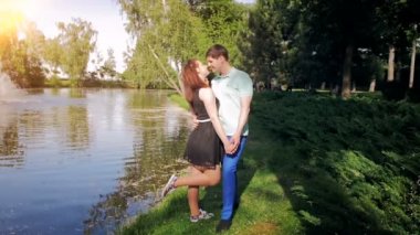 Nehir kıyısındaki aşk öpüşme içinde genç çiftin Slow motion video