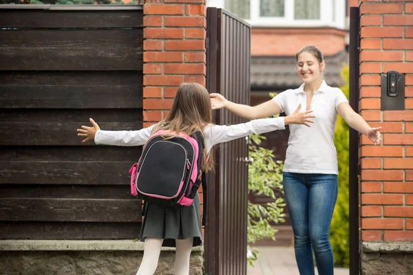 Glad tonårsflicka som kör till sin mor efter att gå från skolan — Stockfoto