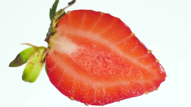 Macro 4k video of squeezing and crushing fresh ripe strawberry. Perfect abstract backdrop for organic food and healthy nutrition. Closeup of berries — Stock Video