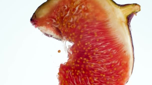 Macro 4k video di spremitura e frantumazione di fichi freschi maturi. Perfetto sfondo astratto per alimenti biologici e una sana alimentazione. Primo piano dei frutti esplosi e del succo che scorre — Video Stock