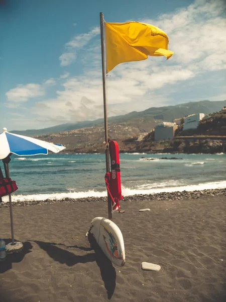 Toned image of coastal quard life saving equipment lying on ocean beach at windy day — Stock Photo, Image