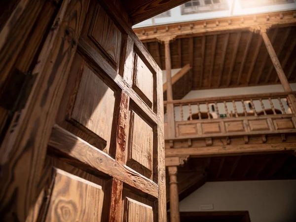 Closeup image of old wooden balcony and heavy wooden door at old house — Stock Photo, Image