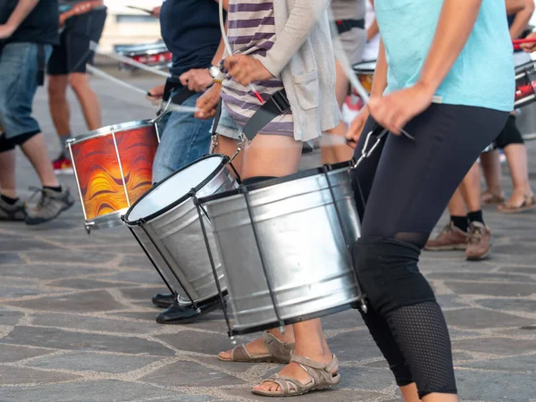 Closeup photo of group of street musicians playing on drum during carnival or holiday — Stock Photo, Image