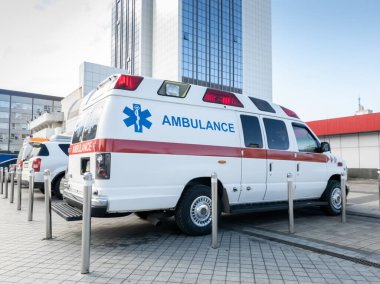 Büyük modern hastanenin otoparkındaki ambulans arabalarının görüntüleri.