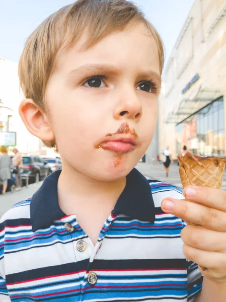 Closeup toned portrait of little boy with dirty mouth after eating ice cream — Stock Photo, Image