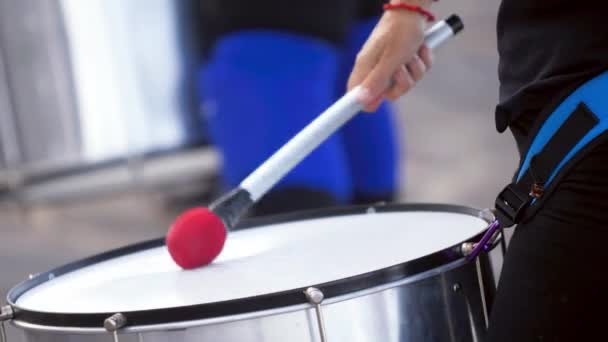 Closeup 4k video of street musician playing on big drum with stick. Culture festival or preformance on city street — Αρχείο Βίντεο